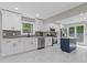 Modern kitchen with stainless steel appliances, dark backsplash, and a blue kitchen island at 4718 Lou Ivy Rd, Peachtree Corners, GA 30096