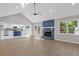 Open-concept living room with fireplace, recessed lighting, and wood-look flooring at 4718 Lou Ivy Rd, Peachtree Corners, GA 30096