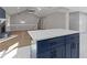 A modern living space features an open floor plan and a blue island with a white marble countertop at 4718 Lou Ivy Rd, Peachtree Corners, GA 30096