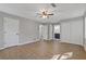 Large primary bedroom features hardwood floors, ceiling fan, and ensuite bathroom at 4718 Lou Ivy Rd, Peachtree Corners, GA 30096