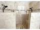 New bathroom featuring dual showers with built in shelves and bench surrounded by neutral colored tiles at 11212 Snowy Owl Ln, Alpharetta, GA 30022