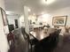 Large dining room open to modern kitchen with large granite island at 11212 Snowy Owl Ln, Alpharetta, GA 30022
