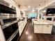 Spacious kitchen boasting granite countertops, stainless steel appliances, and a cozy breakfast area at 11212 Snowy Owl Ln, Alpharetta, GA 30022