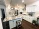 Bright, open kitchen with white cabinetry, stainless appliances, granite counters, and a large island at 11212 Snowy Owl Ln, Alpharetta, GA 30022
