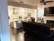 Open-concept living room with a modern kitchen and fireplace at 11212 Snowy Owl Ln, Alpharetta, GA 30022