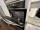 Modern, stainless steel oven with open door showing interior at 11212 Snowy Owl Ln, Alpharetta, GA 30022