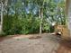 Large and private backyard with a deck and mature trees at 2438 Shadburn Ferry Dr, Buford, GA 30518