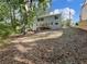 Expansive backyard featuring a wooden deck and mature trees creating a private, natural setting for outdoor enjoyment at 2438 Shadburn Ferry Dr, Buford, GA 30518