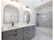 Bathroom featuring double vanity, black hardware, and tiled shower at 2438 Shadburn Ferry Dr, Buford, GA 30518