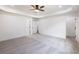 Large bedroom with tray ceilings, neutral carpet, and multiple closets at 2438 Shadburn Ferry Dr, Buford, GA 30518