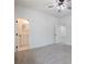 Spacious bedroom features neutral carpet, ceiling fan, and a doorway to an ensuite bathroom at 2438 Shadburn Ferry Dr, Buford, GA 30518
