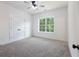 Bedroom with neutral carpet, bright natural light, and a double door closet at 2438 Shadburn Ferry Dr, Buford, GA 30518