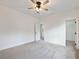 Bedroom with neutral carpet, white trim, and a ceiling fan at 2438 Shadburn Ferry Dr, Buford, GA 30518