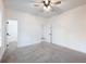 Bright bedroom featuring neutral carpet, ceiling fan, and a walk-in closet at 2438 Shadburn Ferry Dr, Buford, GA 30518
