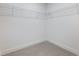 Walk-in closet with neutral carpet, white walls, and installed wire shelving at 2438 Shadburn Ferry Dr, Buford, GA 30518