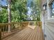 New wooden deck offering a private outdoor space perfect for entertaining or relaxing, with views of the surrounding greenery at 2438 Shadburn Ferry Dr, Buford, GA 30518