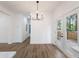 Open dining room with modern lighting and access to the deck, great for entertaining at 2438 Shadburn Ferry Dr, Buford, GA 30518