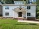 Charming new construction home featuring a classic design, a covered porch, and a well-manicured lawn at 2438 Shadburn Ferry Dr, Buford, GA 30518