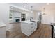 Open-concept kitchen with a large island, modern appliances, and a view of the living area at 2438 Shadburn Ferry Dr, Buford, GA 30518