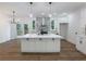 Modern kitchen featuring a large island, pendant lighting, and views of the backyard deck at 2438 Shadburn Ferry Dr, Buford, GA 30518
