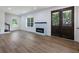 Well-lit living room with a modern fireplace, stylish wood-look floors, and natural light at 2438 Shadburn Ferry Dr, Buford, GA 30518