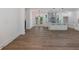 Open-concept living space with a modern kitchen and a cozy dining area featuring wood-look flooring at 2438 Shadburn Ferry Dr, Buford, GA 30518