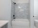 Tile shower with niche, black hardware, and glass enclosure at 2438 Shadburn Ferry Dr, Buford, GA 30518