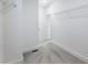 Bright walk-in closet featuring white walls, carpet, and wire shelving for optimal organization at 2438 Shadburn Ferry Dr, Buford, GA 30518