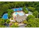 Aerial view of community pool, tennis courts, and clubhouse surrounded by trees at 3605 Grey Abbey Dr, Alpharetta, GA 30022