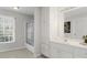 Bathroom featuring double sink vanity, large mirror, storage, and shower over tub combo at 3605 Grey Abbey Dr, Alpharetta, GA 30022