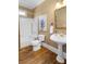 Bathroom boasts hardwood floors, a pedestal sink, and a shower with tub at 3605 Grey Abbey Dr, Alpharetta, GA 30022