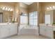 Large bathroom with double sinks, soaking tub and window at 3605 Grey Abbey Dr, Alpharetta, GA 30022