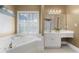 Bathroom featuring soaking tub, large mirrors and window at 3605 Grey Abbey Dr, Alpharetta, GA 30022