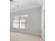 Bright bedroom featuring a vaulted ceiling, large window with blinds, and neutral carpeting at 3605 Grey Abbey Dr, Alpharetta, GA 30022