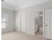 Bedroom with window, carpet, and multiple doors, including en suite bath access at 3605 Grey Abbey Dr, Alpharetta, GA 30022