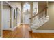Inviting foyer features hardwood floors, a staircase, and a view of the front door with a transom window at 3605 Grey Abbey Dr, Alpharetta, GA 30022