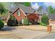 Two-story brick house featuring well-maintained landscaping, large driveway, and attached garage at 3605 Grey Abbey Dr, Alpharetta, GA 30022