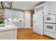 Bright kitchen features white cabinetry, stainless steel appliances, and hardwood floors at 3605 Grey Abbey Dr, Alpharetta, GA 30022