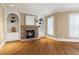 Cozy living room with stone fireplace and built-in shelving and hardwood floors at 3605 Grey Abbey Dr, Alpharetta, GA 30022