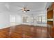 Bright living room with hardwood floors, a ceiling fan, and built-in shelving at 3605 Grey Abbey Dr, Alpharetta, GA 30022