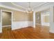 Spacious living room with hardwood floors, decorative molding, and chandelier at 3605 Grey Abbey Dr, Alpharetta, GA 30022