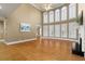 Open-concept living room features hardwood floors, tall windows, and a fireplace at 3605 Grey Abbey Dr, Alpharetta, GA 30022