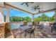 Inviting outdoor patio with stone floor, stone columns, ceiling fans, and views of the pool and property at 3605 Grey Abbey Dr, Alpharetta, GA 30022