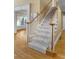 Carpeted staircase featuring wood banister and white railings at 3605 Grey Abbey Dr, Alpharetta, GA 30022
