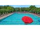 An outdoor pool surrounded by chairs, umbrellas, and lush greenery at 3605 Grey Abbey Dr, Alpharetta, GA 30022