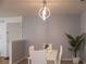 Cozy dining area features modern chandelier and neutral gray paint at 4203 Fairington Village Dr, Lithonia, GA 30038