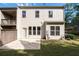 Back of home with a concrete patio and a grassy yard is ideal for relaxation and entertaining at 4236 Silver Spruce Ln, Smyrna, GA 30080