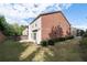 Two-story home with red brick and neutral siding, a small patio, and green lawn is the perfect setting for outdoor enjoyment at 4236 Silver Spruce Ln, Smyrna, GA 30080