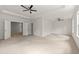 Spacious, carpeted bedroom featuring multiple windows and recessed lighting, with attached rooms via white panel doors at 4236 Silver Spruce Ln, Smyrna, GA 30080