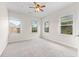 Bright, spacious bedroom with large windows, ceiling fan, and neutral-toned carpet at 4236 Silver Spruce Ln, Smyrna, GA 30080